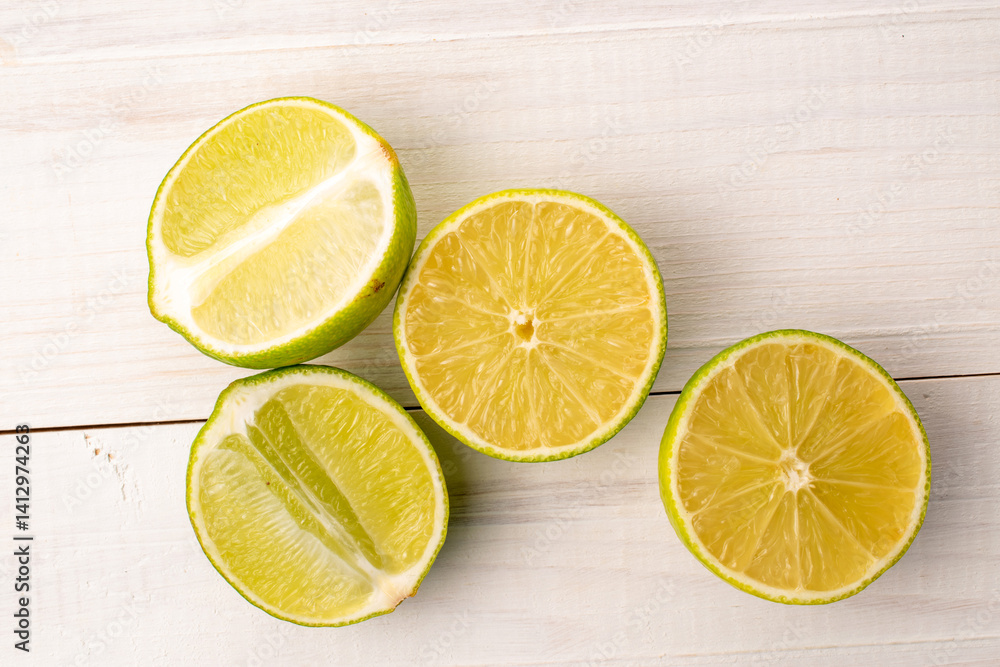 Cut juicy limes on a wooden table, close-up, top view. Cut juicy limes on a wooden table, close-up, top view.