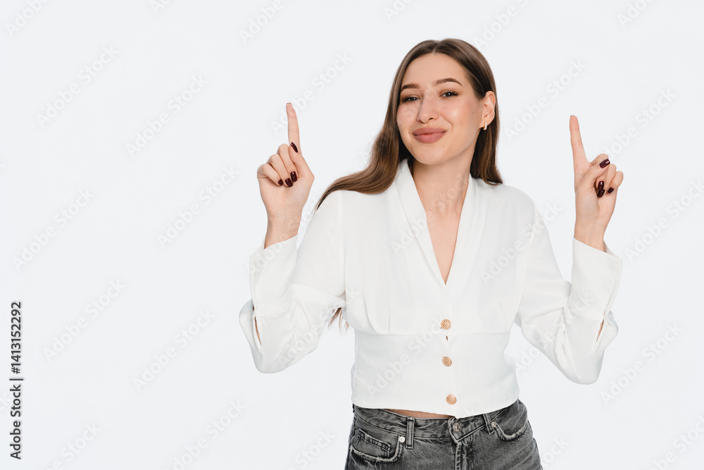 Stylish young caucasian woman sale manager smiling, pointing fingers up, showing advertisement, promo offer, standing against white background. People promo concept Stylish young caucasian woman sale manager smiling, pointing fingers up, showing advertisement, promo offer, standing against white background. People promo concept