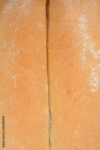 Obraz na plátně A close-up shot captures the textured surface of a white bread roll, highlightin