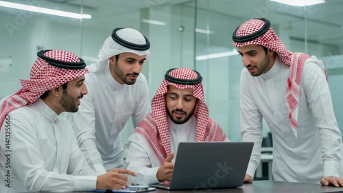 Wallpaper Mural Saudi business team in traditional attire collaborating on laptop in office, ideal for teamwork, corporate planning, or business culture in Middle East settings. Torontodigital.ca