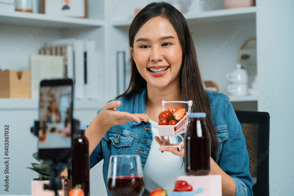 Smiling young beautiful Asian reviewing tasty mixed strawberry and cherry juice detox drinks, showing healthy product to promote for special promotion selling on social media online record. Stratagem. Smiling young beautiful Asian reviewing tasty mixed strawberry and cherry juice detox drinks, showing healthy product to promote for special promotion selling on social media online record. Stratagem.
