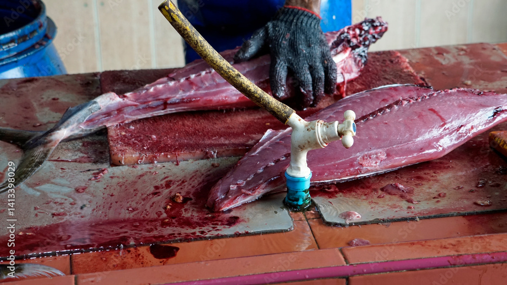 preparing fresh tuna steak at the fish market