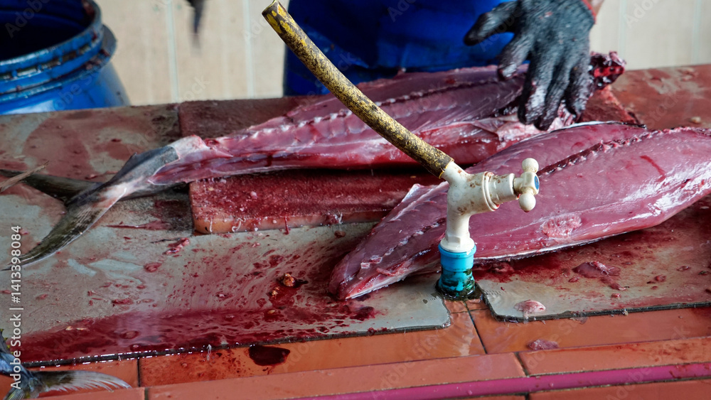 preparing fresh tuna steak at the fish market