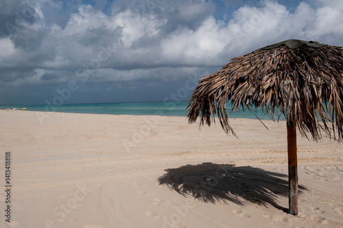 Varadero Beach, Cuba. The empty tropical beach clad with thatched umbrellas for tourists.