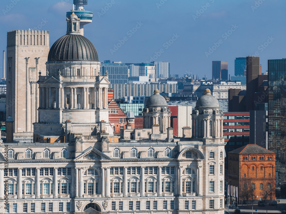 Aerial view of Liverpool showcasing the Port of Liverpool Building, Radio City Tower, and a mix of modern and historic architecture, including red brick structures.