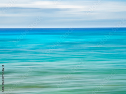 Blurred abstract of blue and green sea and sky.