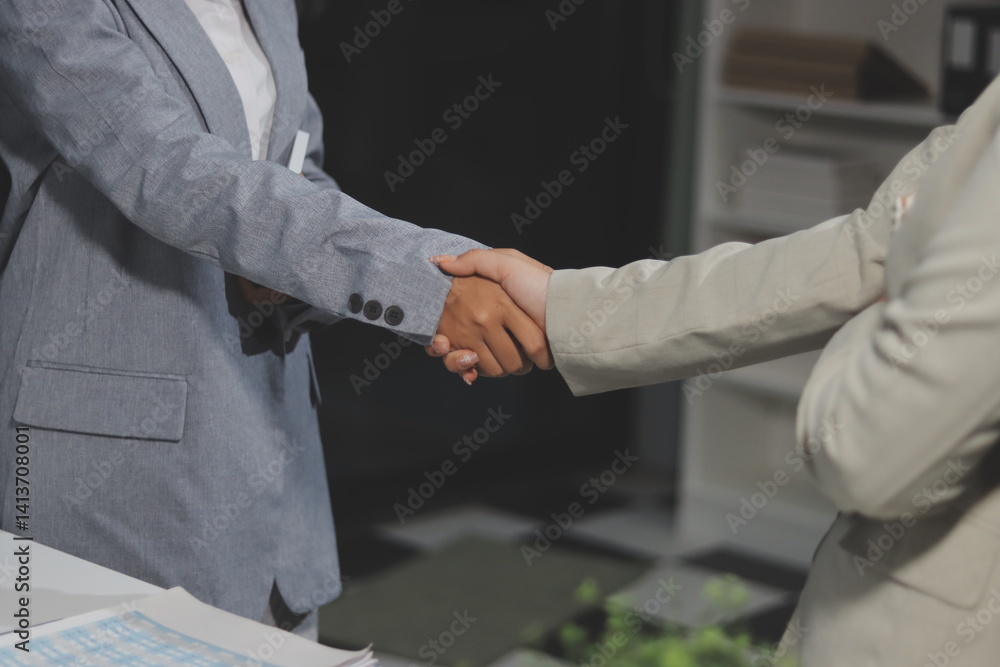 Fototapeta premium Business handshake for teamwork of business merger and acquisition,successful negotiate,hand shake,two businessman shake hand with partner to celebration partnership and business deal concept.