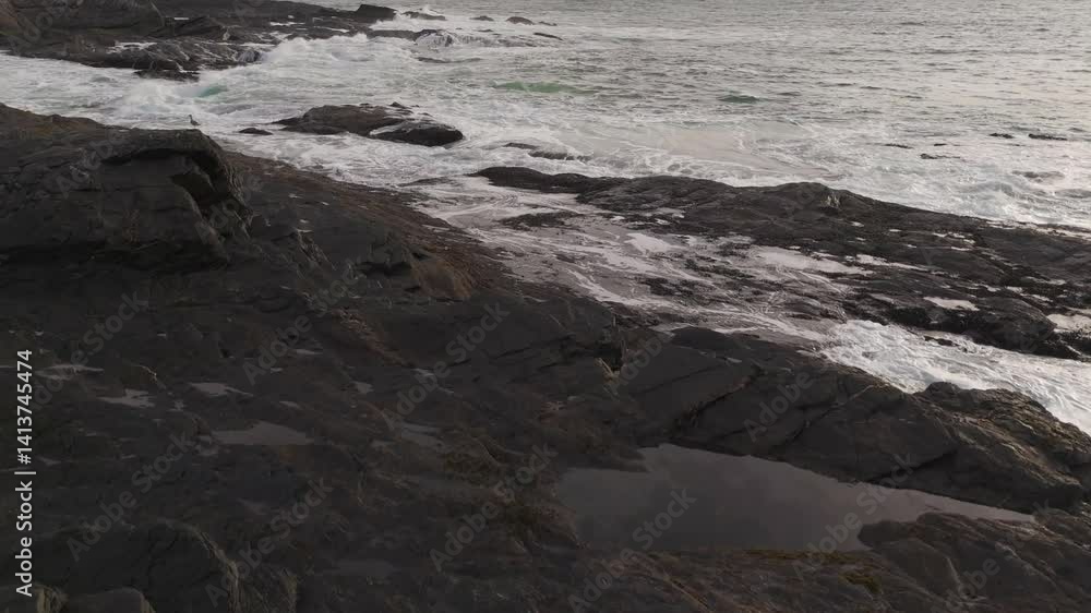Ocean Waves Crashing on the Rocky Beach of Vancouver Island at Sunset Ocean Waves Crashing on the Rocky Beach of Vancouver Island at Sunset
