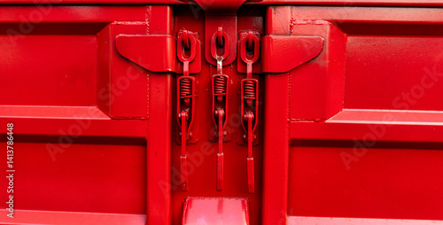 Red Truck Latch Mechanism Showing Tension Springs and Locking Components