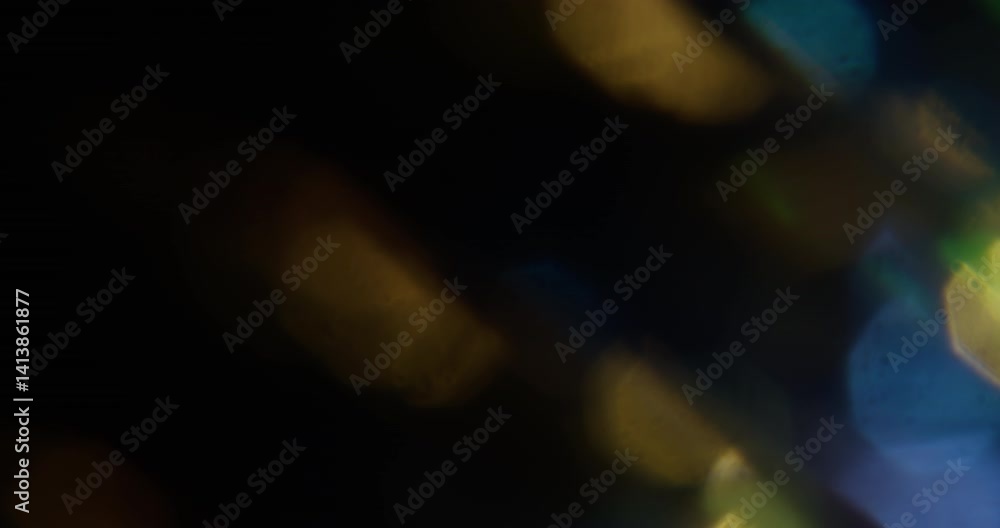 Flare light. Blur optical leak. Defocused blue yellow golden color lens flicker sparkle texture on abstract dark black background. Flare light. Blur optical leak. Defocused blue yellow golden color lens flicker sparkle texture on abstract dark black background.