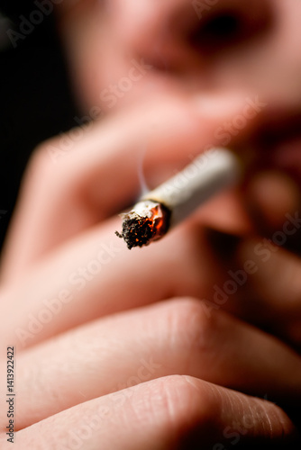 Close-Up of a Burning Cigarette in Hand