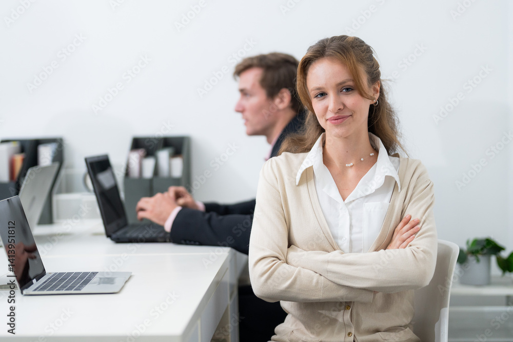 Professional workspace featuring a confident woman and a focused man engaged in productive tasks during office hours Professional workspace featuring a confident woman and a focused man engaged in productive tasks during office hours
