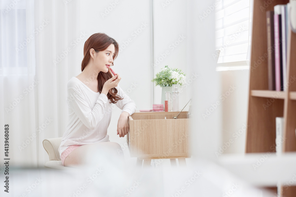 Asian Woman Applying Lipstick at Vanity Table Asian Woman Applying Lipstick at Vanity Table