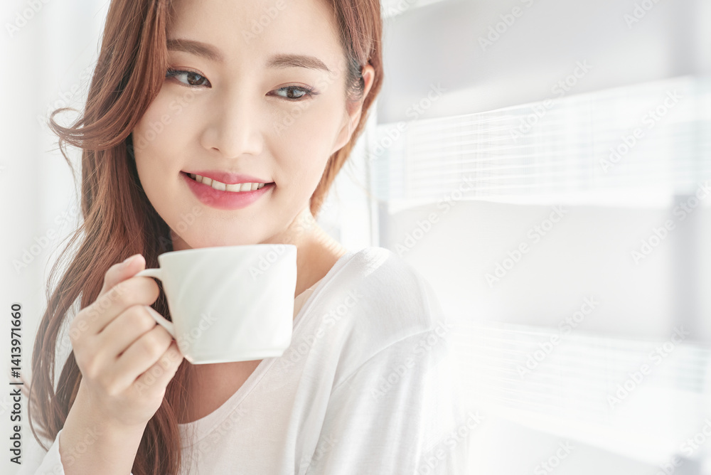 Young Woman Smiling with Coffee Cup Indoors Young Woman Smiling with Coffee Cup Indoors
