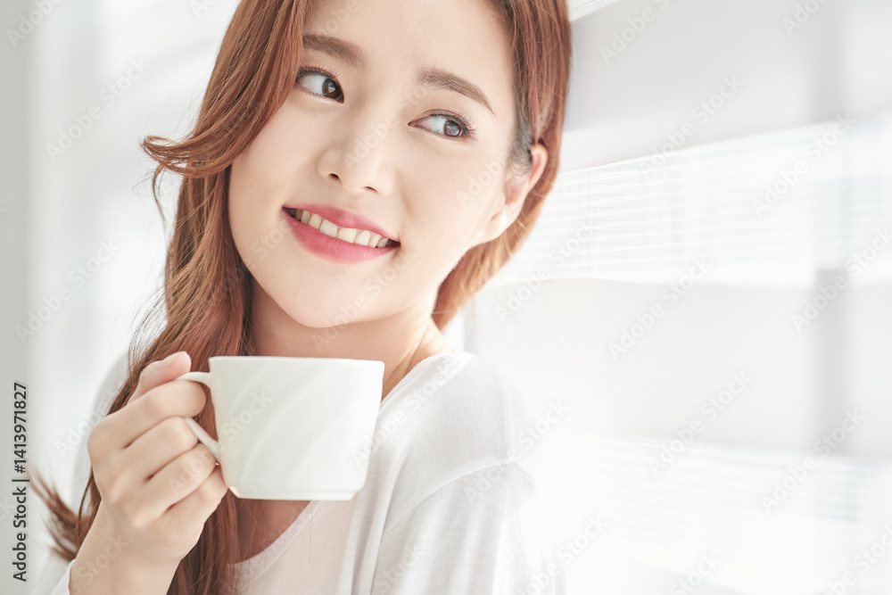 Young Woman Smiling with Coffee Cup Indoors
