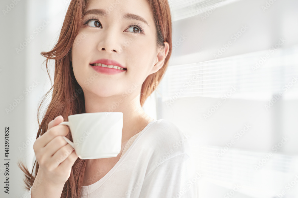 Young Woman Smiling with Coffee Cup Indoors Young Woman Smiling with Coffee Cup Indoors