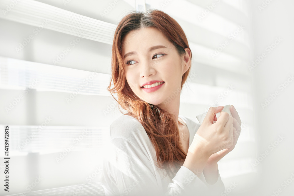 Young Woman Smiling with Coffee Cup Indoors Young Woman Smiling with Coffee Cup Indoors