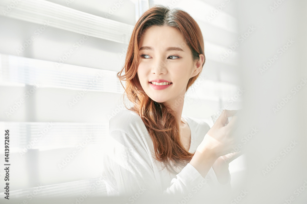 Young Woman Smiling with Coffee Cup Indoors Young Woman Smiling with Coffee Cup Indoors