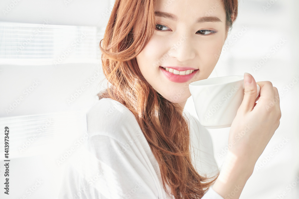 Young Woman Smiling with Coffee Cup Indoors Young Woman Smiling with Coffee Cup Indoors