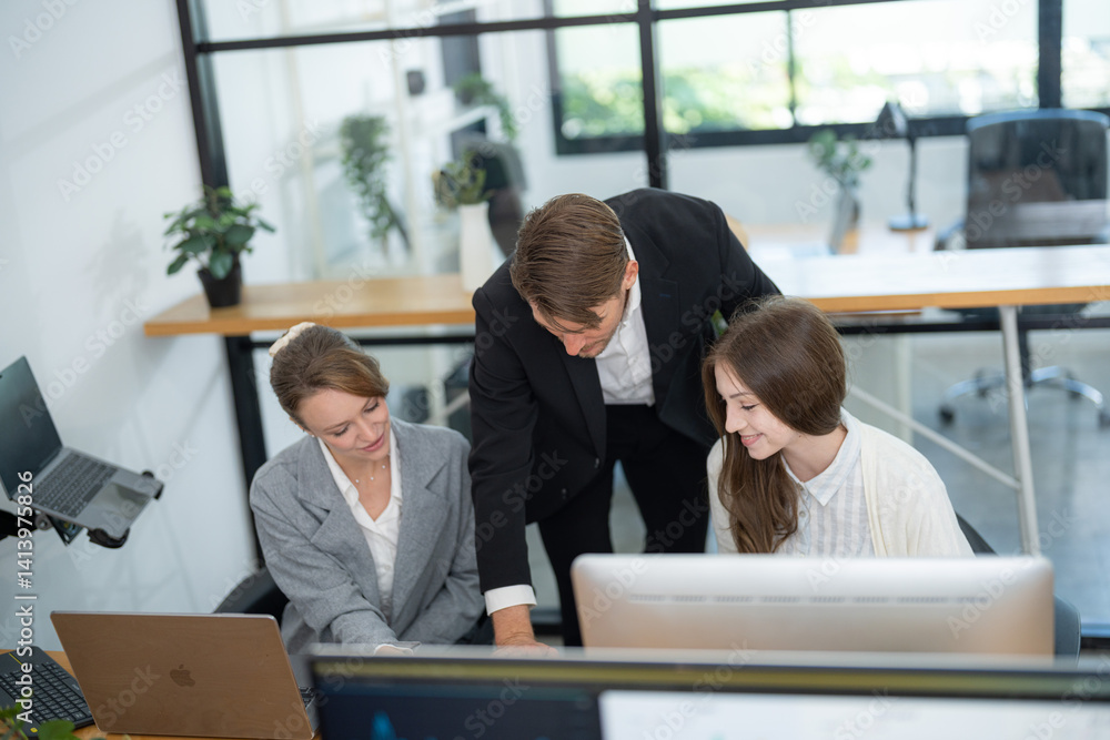 Fototapeta premium Business team collaborates on project in modern office setting during daytime hours