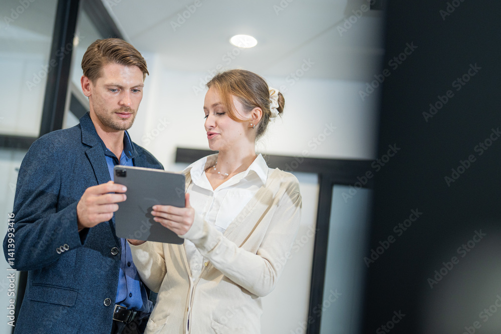 Business colleagues collaborating on a digital project in a modern office setting during a weekday morning Business colleagues collaborating on a digital project in a modern office setting during a weekday morning