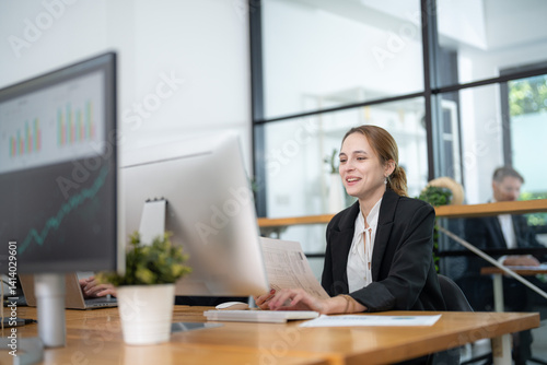 Professional woman engaged in work at a modern office space during daylight hours