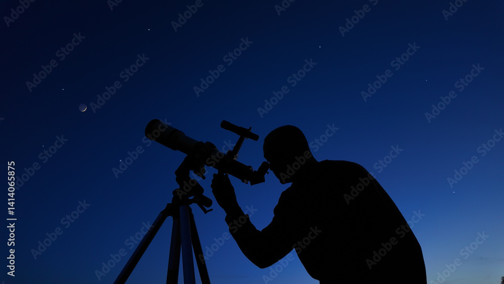 Amateur astronomer looking at the evening skies, observing planets, stars, Moon and other celestial objects with a telescope.
