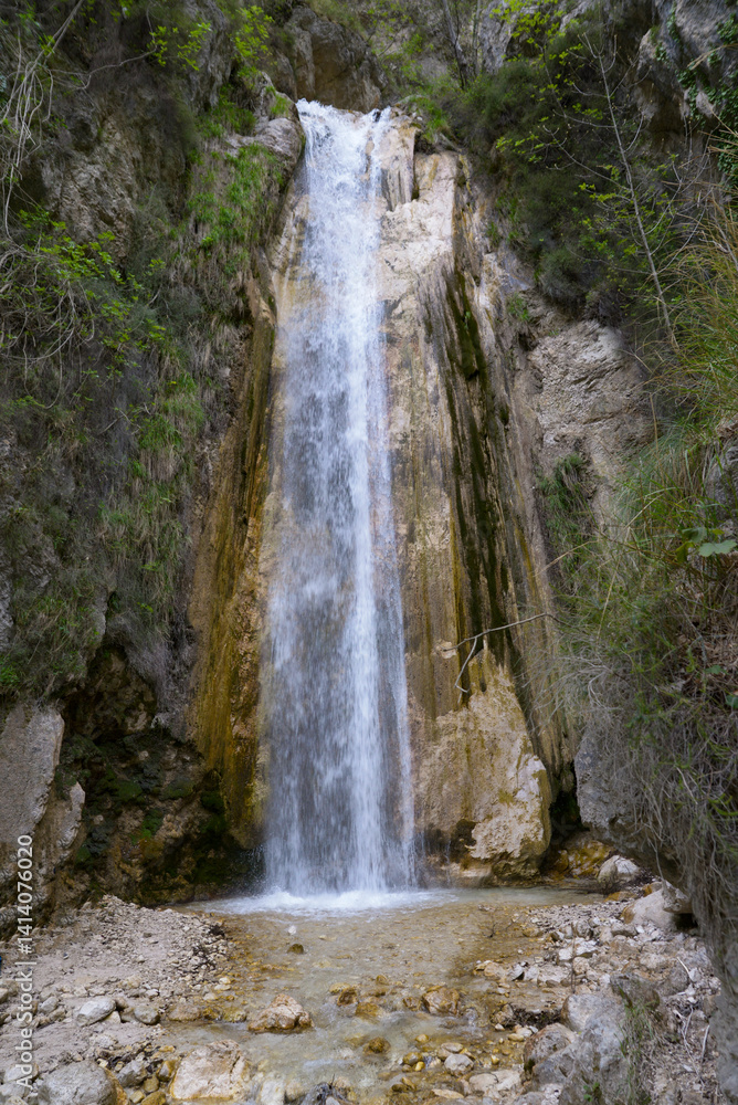 Fototapeta premium Natural waterfalls in the WWF Oasis Valle della Caccia, located in Senerchia, Avellino, Italy. Surrounded by lush forest and rocky cliffs, this hidden gem in southern Italy