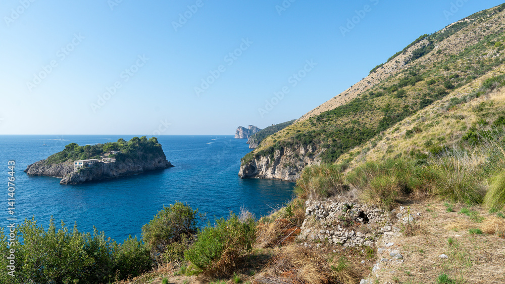 Scenic view of the island of Isca and the Amalfi Coast towards Nerano, seen from the cliffs of Crapolla in Massa Lubrense. A peaceful Mediterranean landscape with blue sea Scenic view of the island of Isca and the Amalfi Coast towards Nerano, seen from the cliffs of Crapolla in Massa Lubrense. A peaceful Mediterranean landscape with blue sea