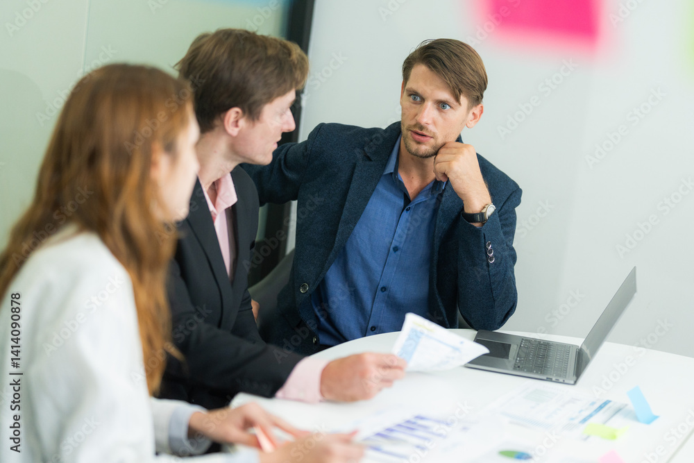 Business professionals discussing project strategies during a meeting in a modern office setting Business professionals discussing project strategies during a meeting in a modern office setting