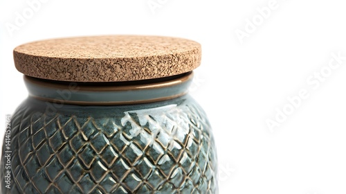Obraz na płótnie Close-up of handcrafted ceramic jar with detailed embossed patterns and natural cork lid, captured in minimalist studio setting on white background for home decor or pottery design themes. w salonie