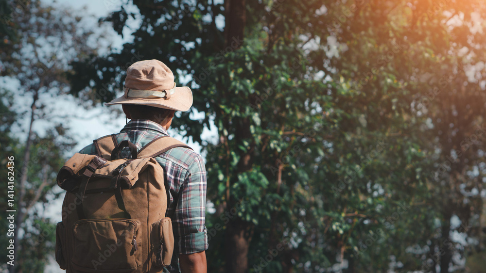 Naklejka premium Travel and backpack concept. A young man is hiking with a backpack in the forest. Close up legs of young asian hiking man standing, Adventure hikes, Enjoy holidays