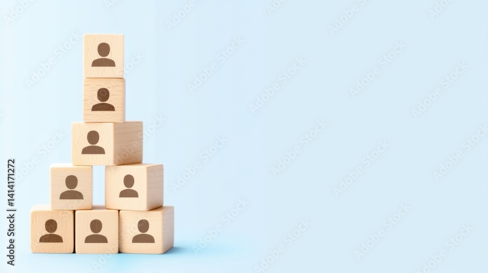 Wooden cubes with human icons arranged in a pyramid on a blue background, symbolizing business hierarchy and team selection.