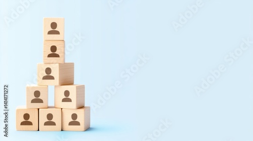 Obraz na płótnie Wooden cubes with human icons arranged in a pyramid on a blue background, symbolizing business hierarchy and team selection. w salonie