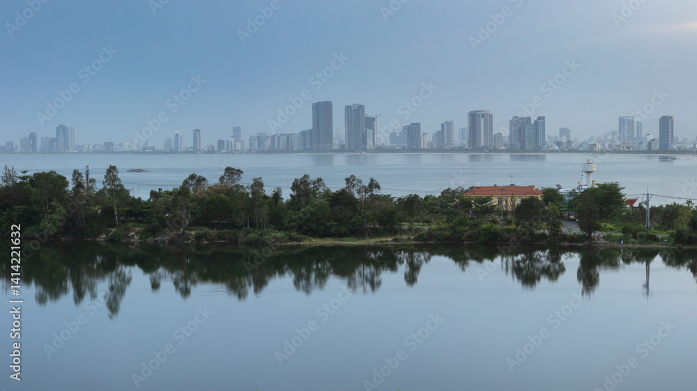 Fototapeta premium Panoramic view of Da Nang city from a scenic viewpoint by the lake on the outskirts of Da Nang city