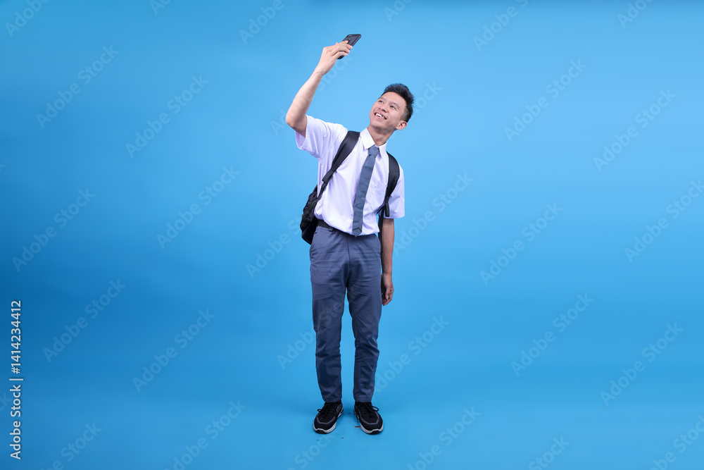 Full Body Length of Indonesian Student Doing Selfie Shot on Mobile Cellphone Post Photo on Social Network Full Body Length of Indonesian Student Doing Selfie Shot on Mobile Cellphone Post Photo on Social Network
