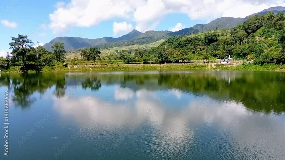 Calm Lake with Mirror-Like Reflection of Sky and Hills – Beautiful Outdoor Nature View, Stunning Reflection of Clouds and Mountains on a Serene Lake – Clear Sky and Lush Forest. Calm Lake with Mirror-Like Reflection of Sky and Hills – Beautiful Outdoor Nature View, Stunning Reflection of Clouds and Mountains on a Serene Lake – Clear Sky and Lush Forest.