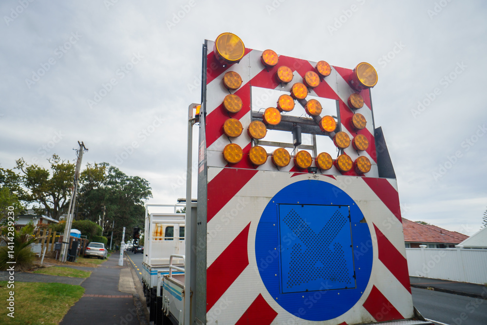 Work truck with cross warning sign. Roadworks in Auckland.