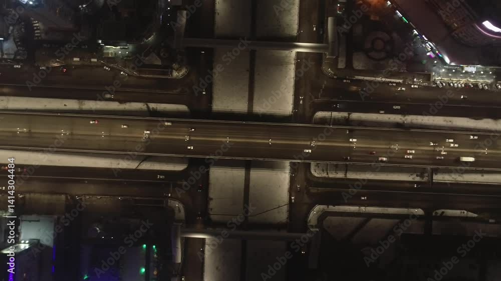 A drone on the nightly lit streets of the city. Cars and trucks are driving along the streets. A cloudless summer night. A drone on the nightly lit streets of the city. Cars and trucks are driving along the streets. A cloudless summer night.