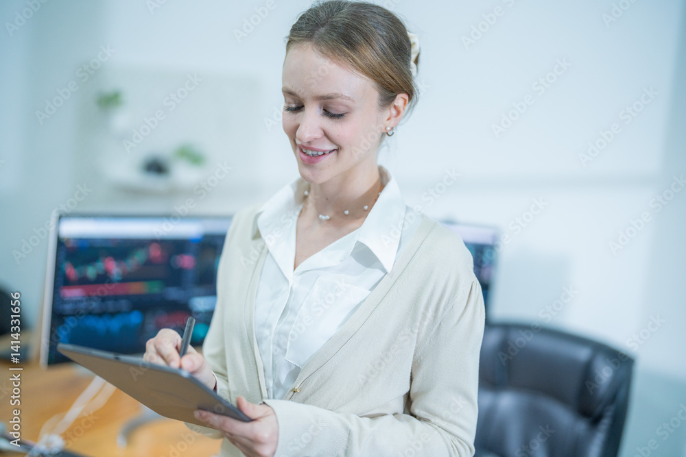 Businesswoman reviews financial data while working with tablet in a modern office environment Businesswoman reviews financial data while working with tablet in a modern office environment