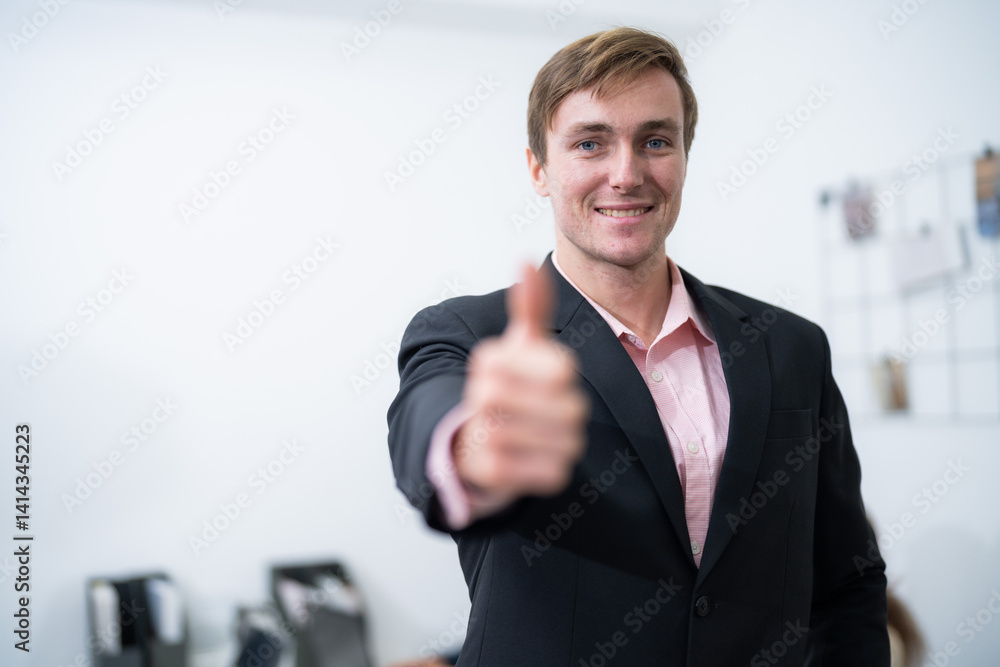 Professional man giving a thumbs up in an office environment while wearing a suit Professional man giving a thumbs up in an office environment while wearing a suit