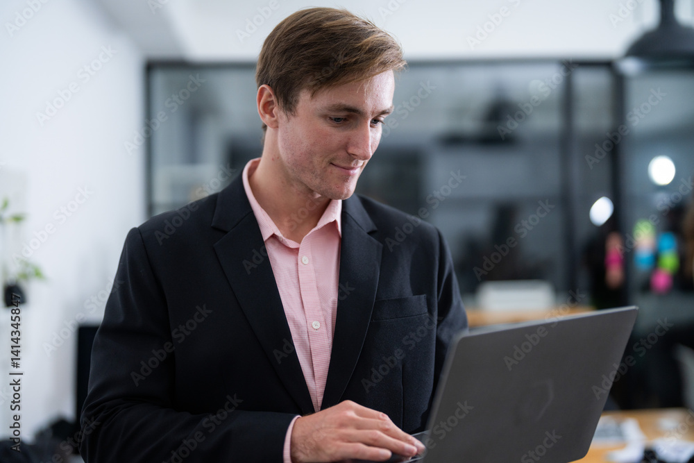 Business professional using laptop in modern office space during daytime for work and collaboration Business professional using laptop in modern office space during daytime for work and collaboration