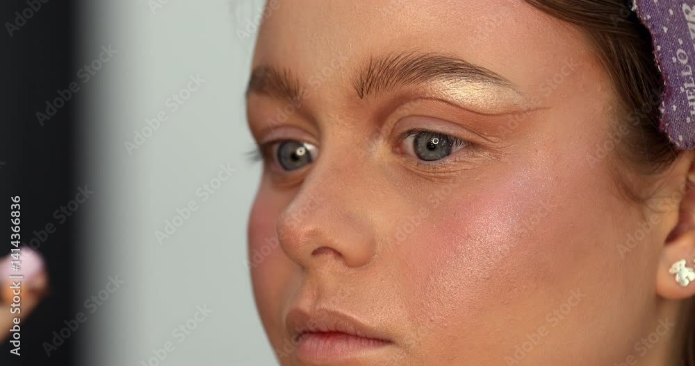 Professional makeup artist working with beautiful young woman. Close up makeup for young model. Makeup artist applying makeup. Professional Make-up artist doing glamour model make up Professional makeup artist working with beautiful young woman. Close up makeup for young model. Makeup artist applying makeup. Professional Make-up artist doing glamour model make up
