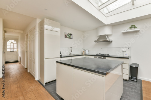Wallpaper Mural A sleek, modern kitchen showcasing minimalist design, featuring white cabinetry, a central island, and large windows for ample natural light. Torontodigital.ca