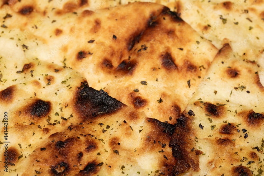 Close up of the surface of a fresh flatbread bread with herbs Close up of the surface of a fresh flatbread bread with herbs