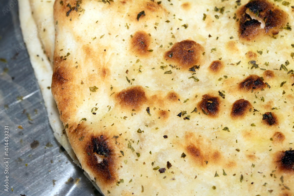 Close up of the surface of a fresh flatbread bread with herbs Close up of the surface of a fresh flatbread bread with herbs