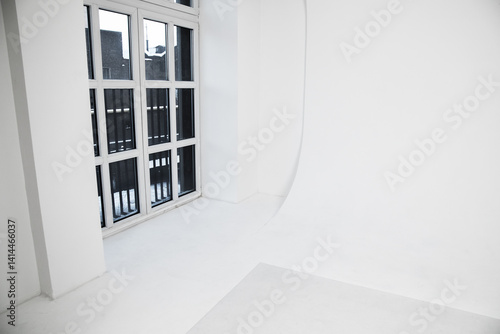 Bright, spacious white room with cyclorama featuring large glass windows