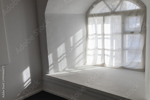 Sunlight streams through a translucent curtain in old room