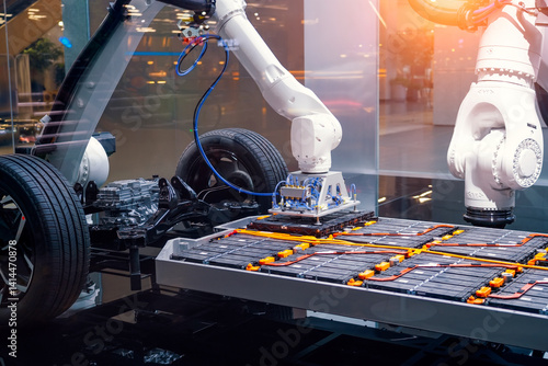 Obraz na plátne Mechanical engineering robotic arm installs lithium ion batteries into machine base, eco transport manufacturing and assembly