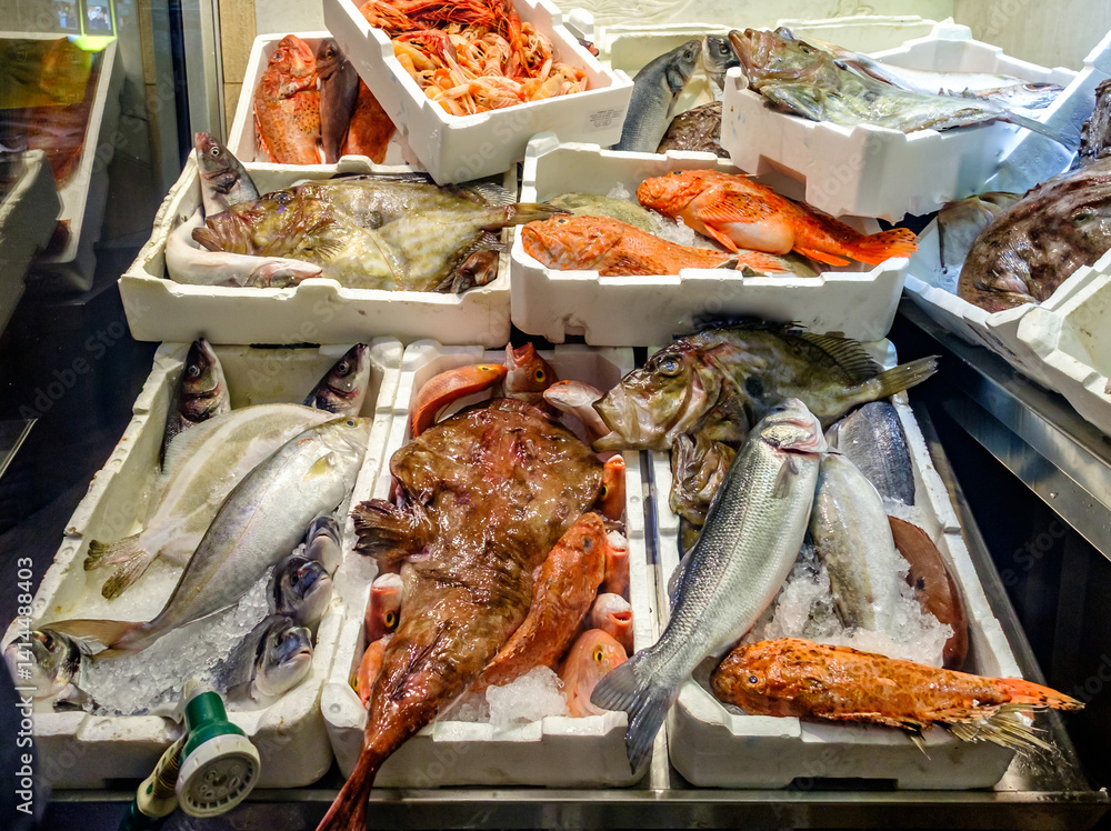 Fresh seafood display at a local market showcasing various fish and shellfish on a busy afternoon in a coastal town